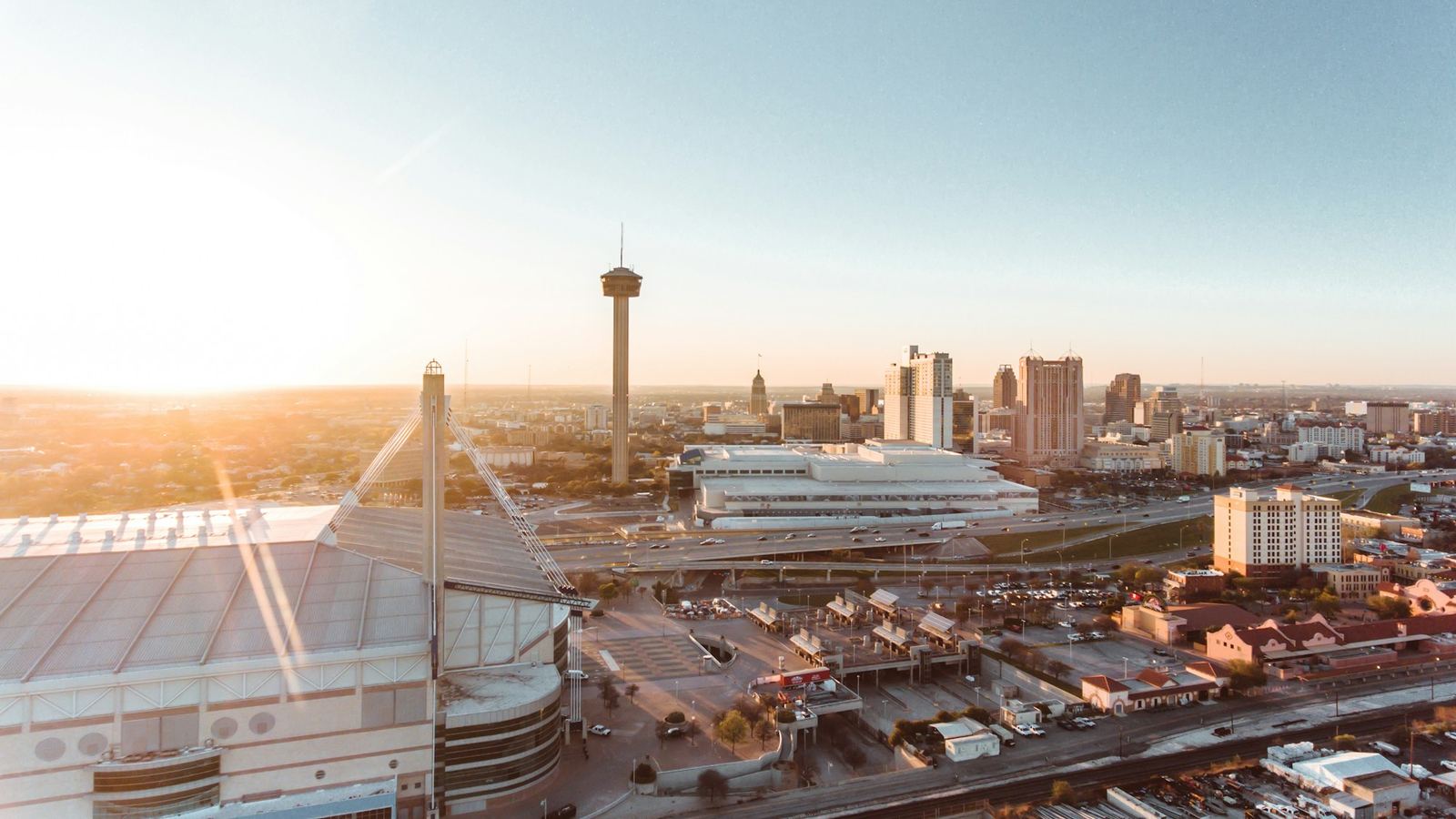 Aerial view of the Alamodome and downtown San Antonio at sunset