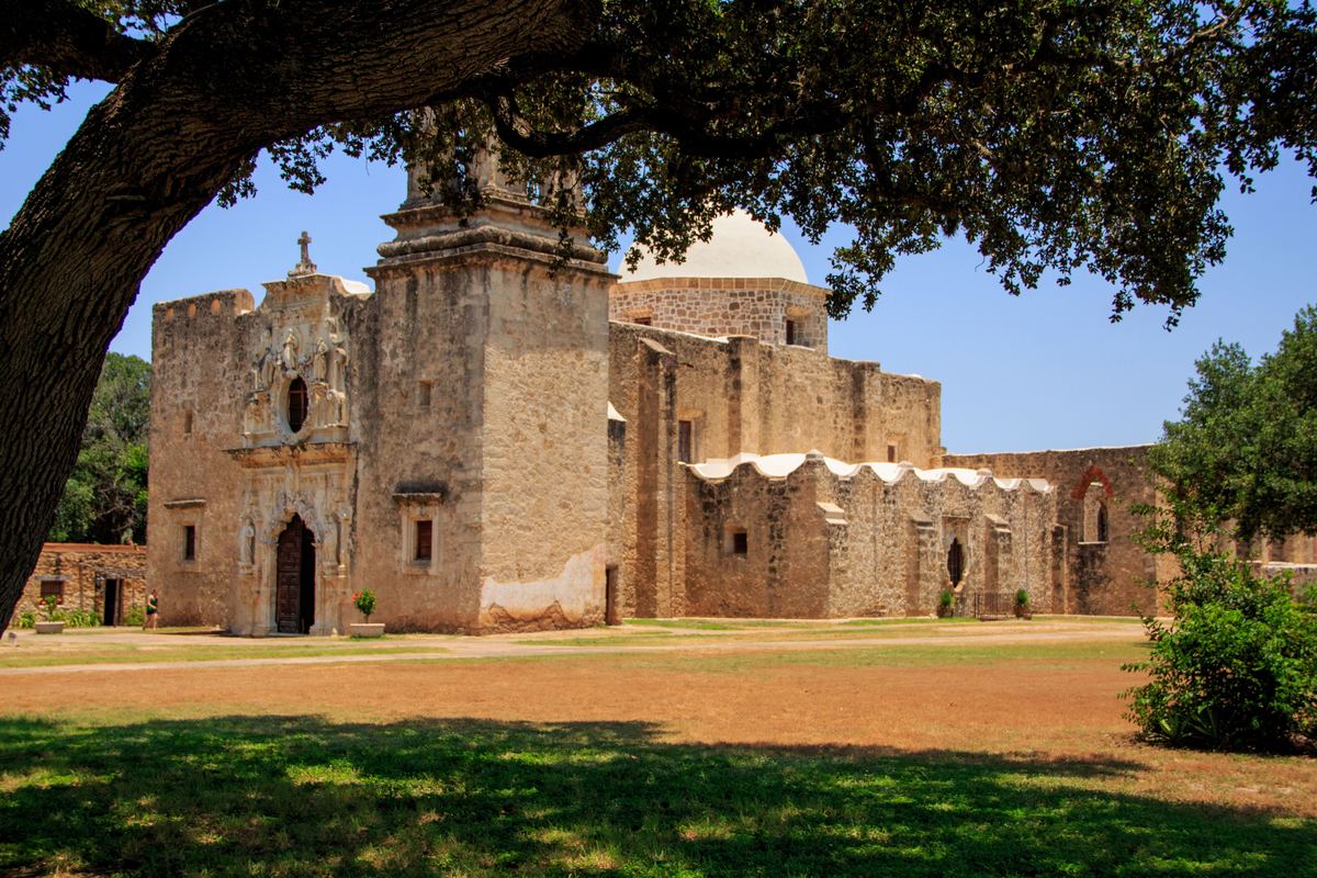Mission San José framed by a live oak branch in San Antonio