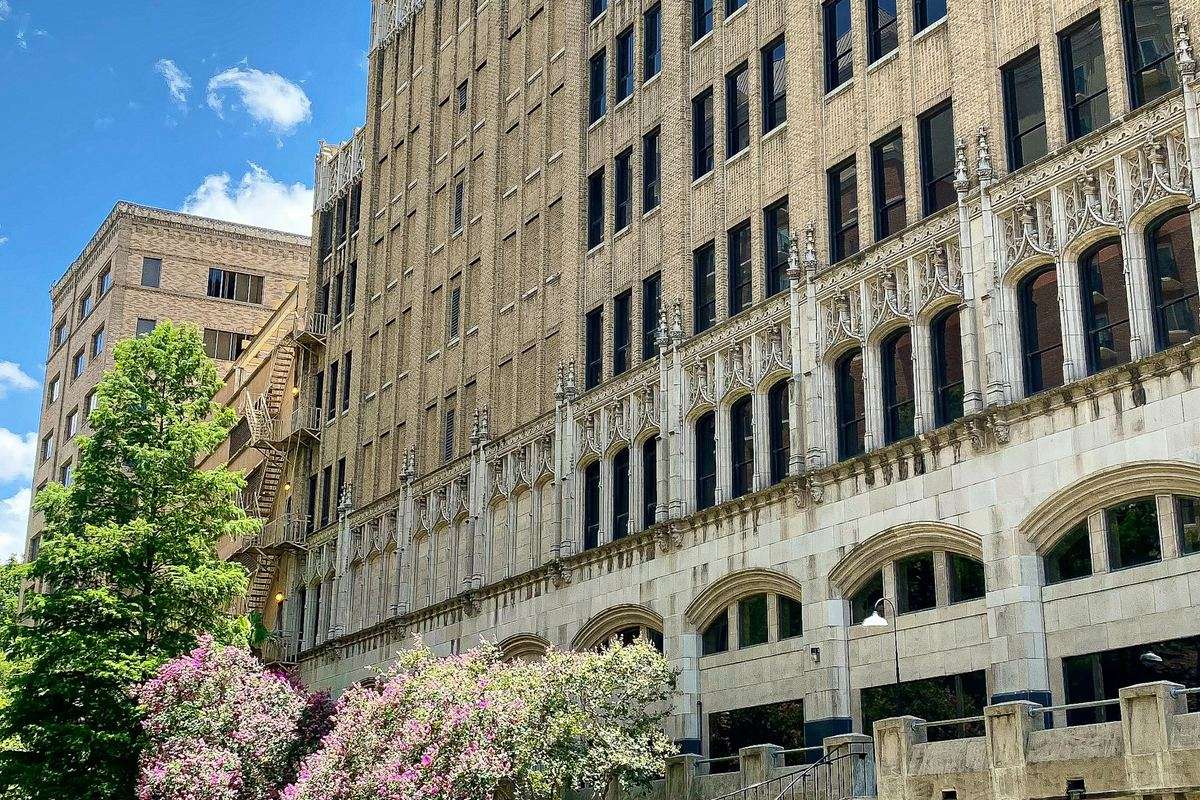 Office building and blooming trees above the San Antonio River