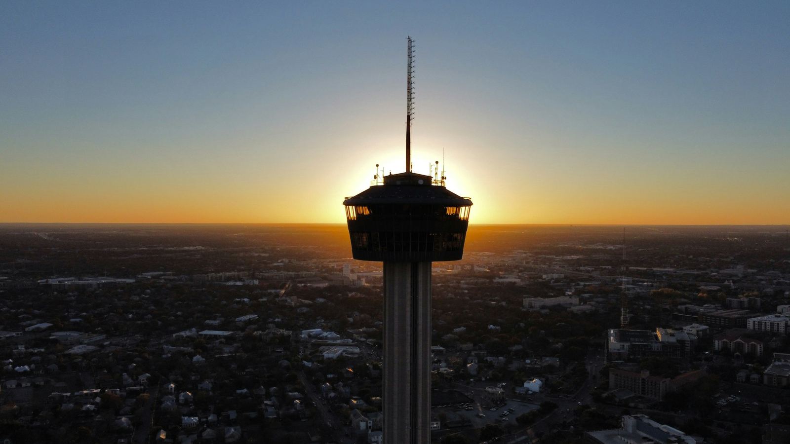 The Tower of the Americas silhouetted above San Antonio at sunset
