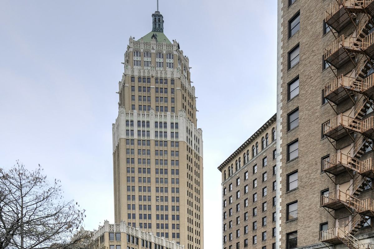 The Tower Life Building rising above a bend of the San Antonio River